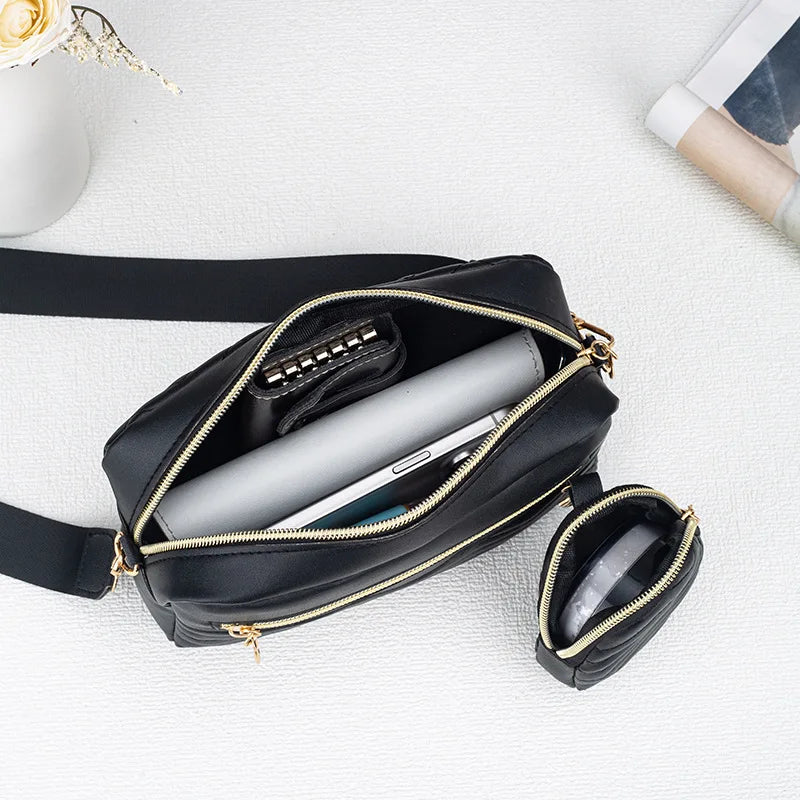 Inside the crossbody bag with a phone, plus the mini pouch